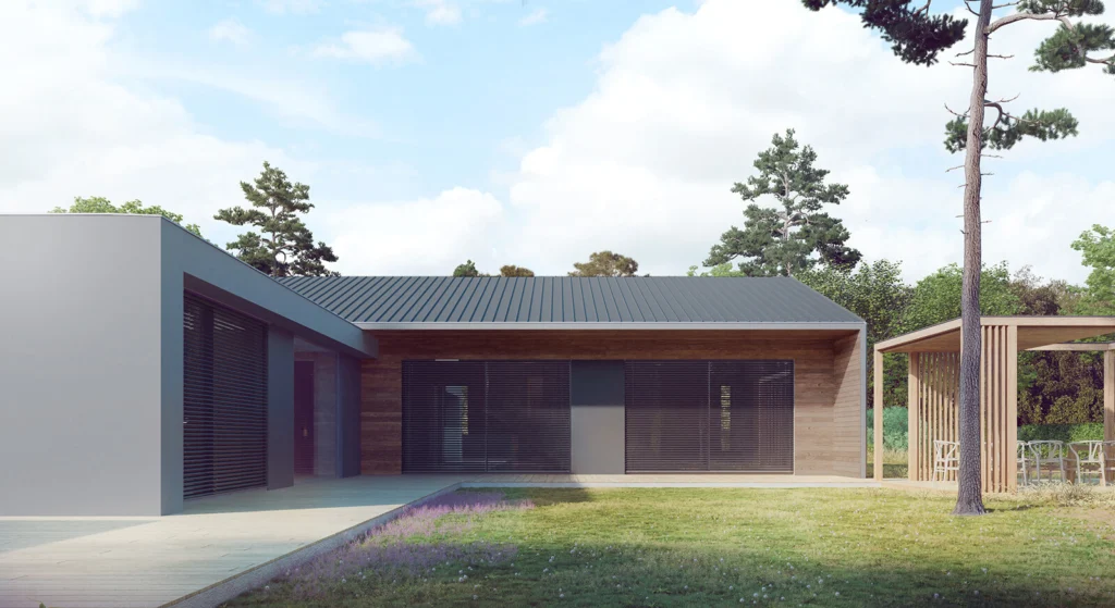 Elewacja frontowa domu bungalow w Jerzmanowie z szarą bryłą garażu, drewnianą okładziną i żaluzjami przy oknach, blaszanym dachem dwuspadowym i drewnianą pergolą na tarasie.